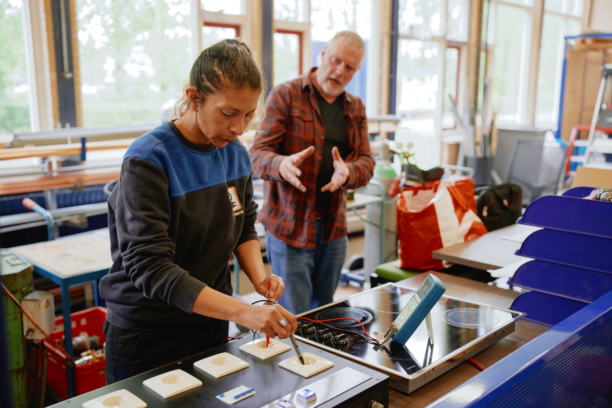 Meisje monteert witgoed-onderdelen onder begeleiding van instructeur in techniekles, Nieuwegein — Stefan Segers Fotografie